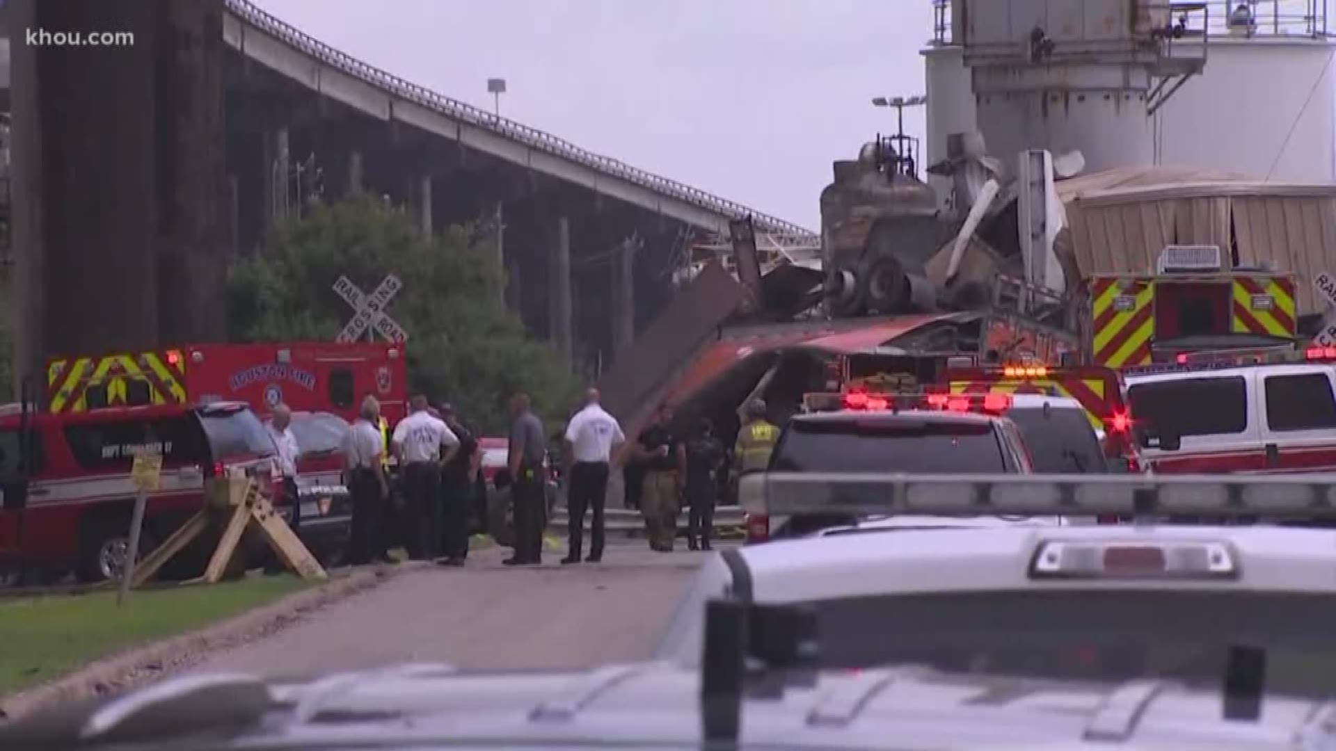 A big rig fell 150 feet from the Ship Channel Bridge Wednesday morning. Police initially said the driver survived the crash and was pinned in the truck awaiting rescue, but a few minutes later police confirmed he died.