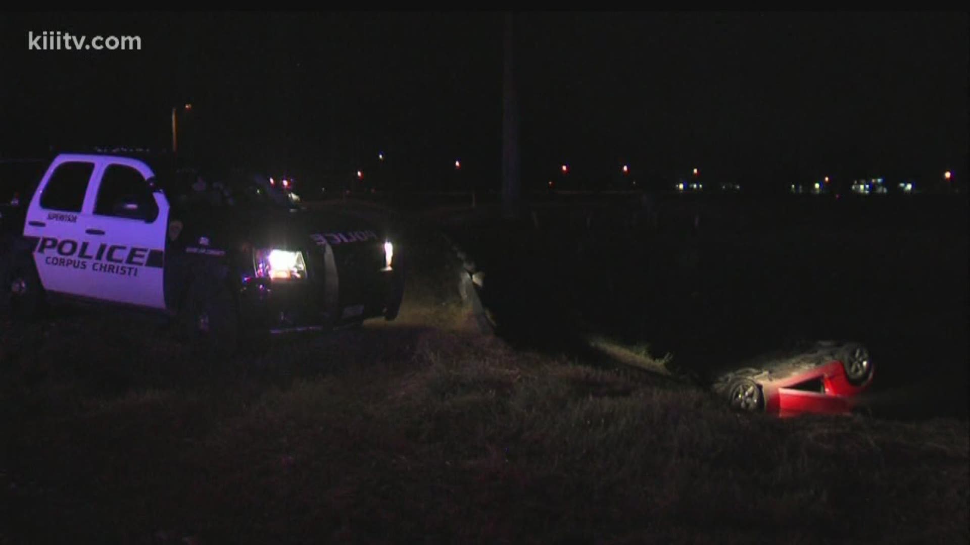 Sports car flips into watery ditch.