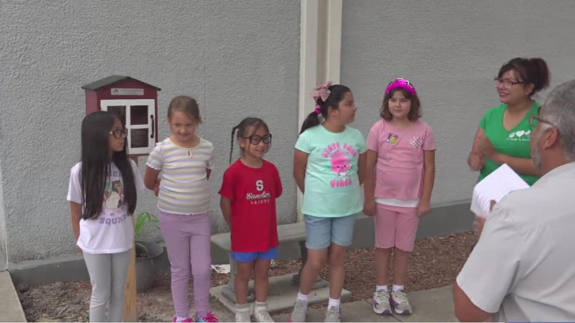 The Girl Scout troop representing Sanders Elementary helped make the library a reality.