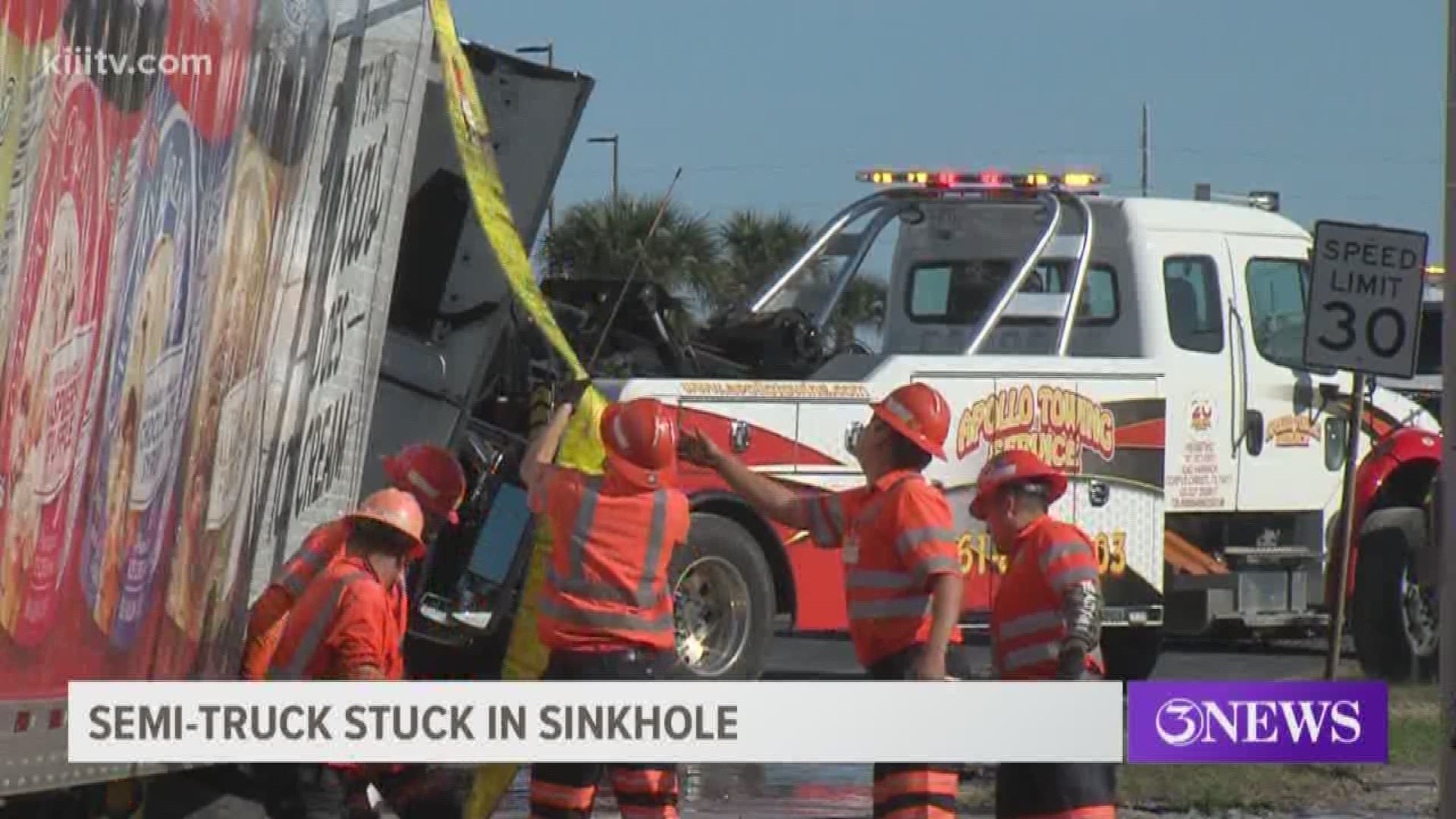 A 3News viewer shared footage from the scene as an H-E-B truck got its front passenger-side tire stuck in a deep, water filled sinkhole near the curb.