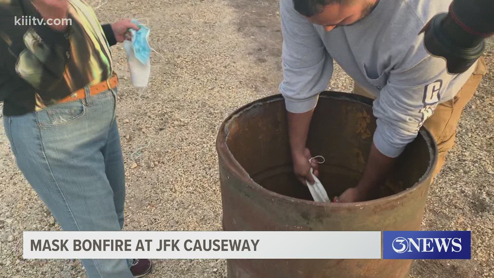 Several residents gathered at the JFK Causeway Wednesday evening for a mask bonfire.