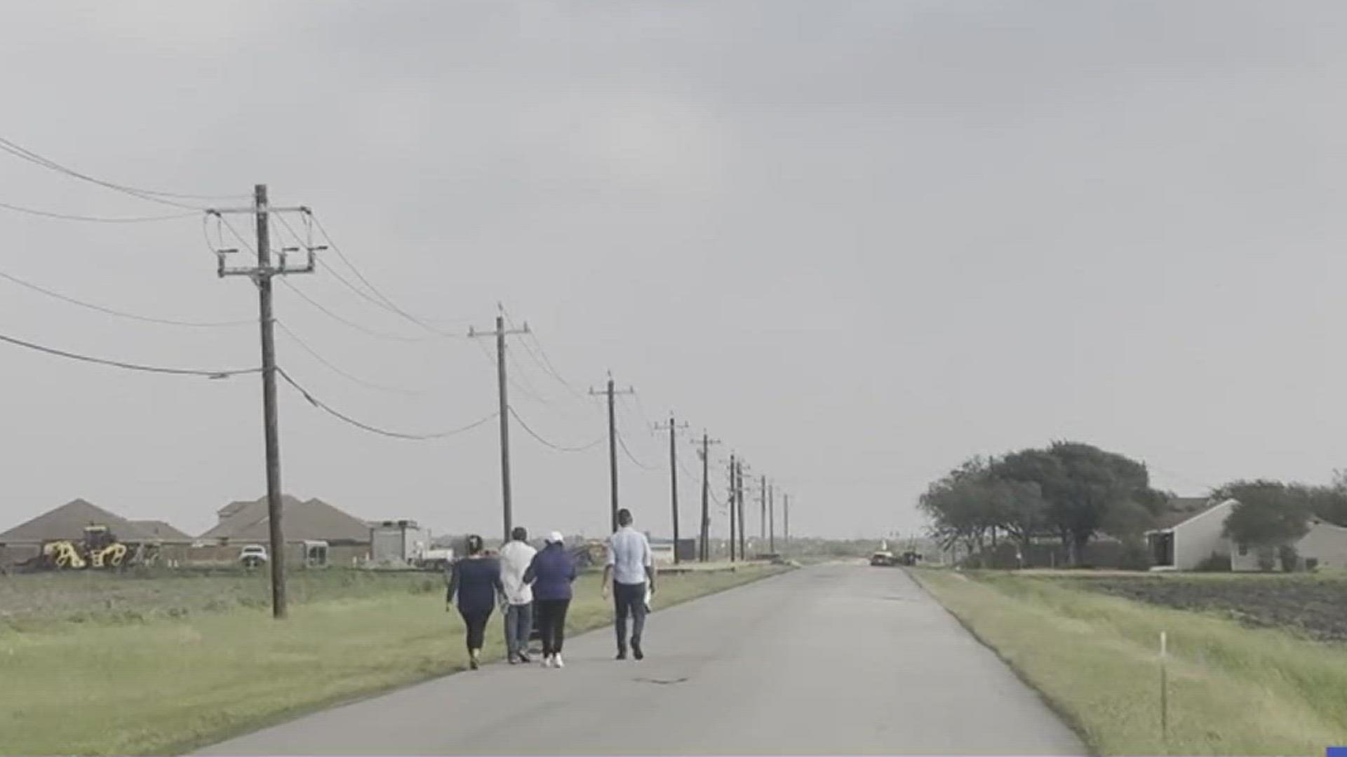 London parents walked along the edge of the road Monday all to raise awareness, holding signs that read 'pedestrian safety for our kids.'