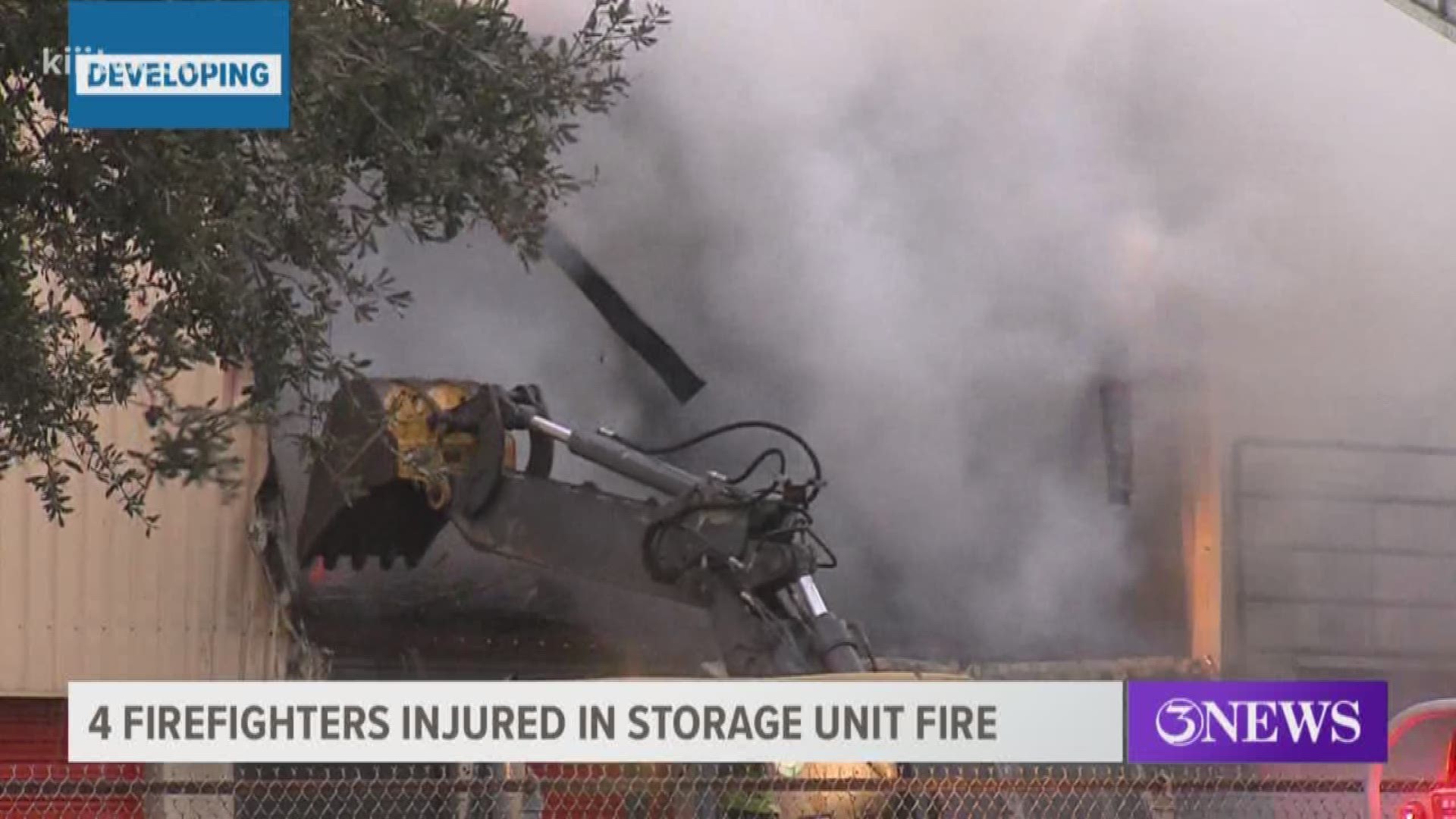 Four firefighters were injured Monday while battling a blaze at a U-Haul storage facility off SPID and Kostoryz Road.