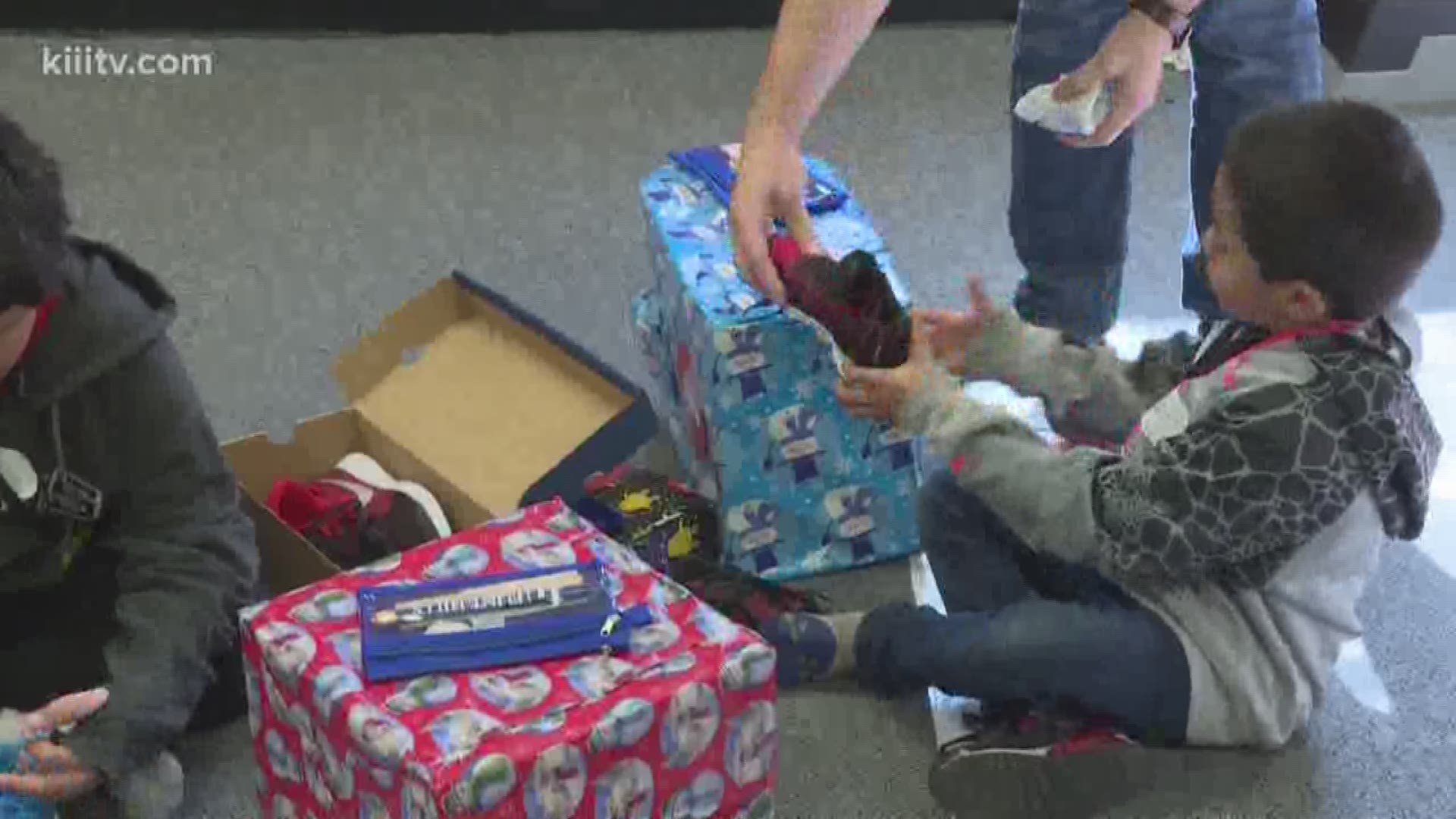 Students from three area schools got some new shoes and presents for Christmas on Friday thanks to Flint Hills Resources and the YMCA.