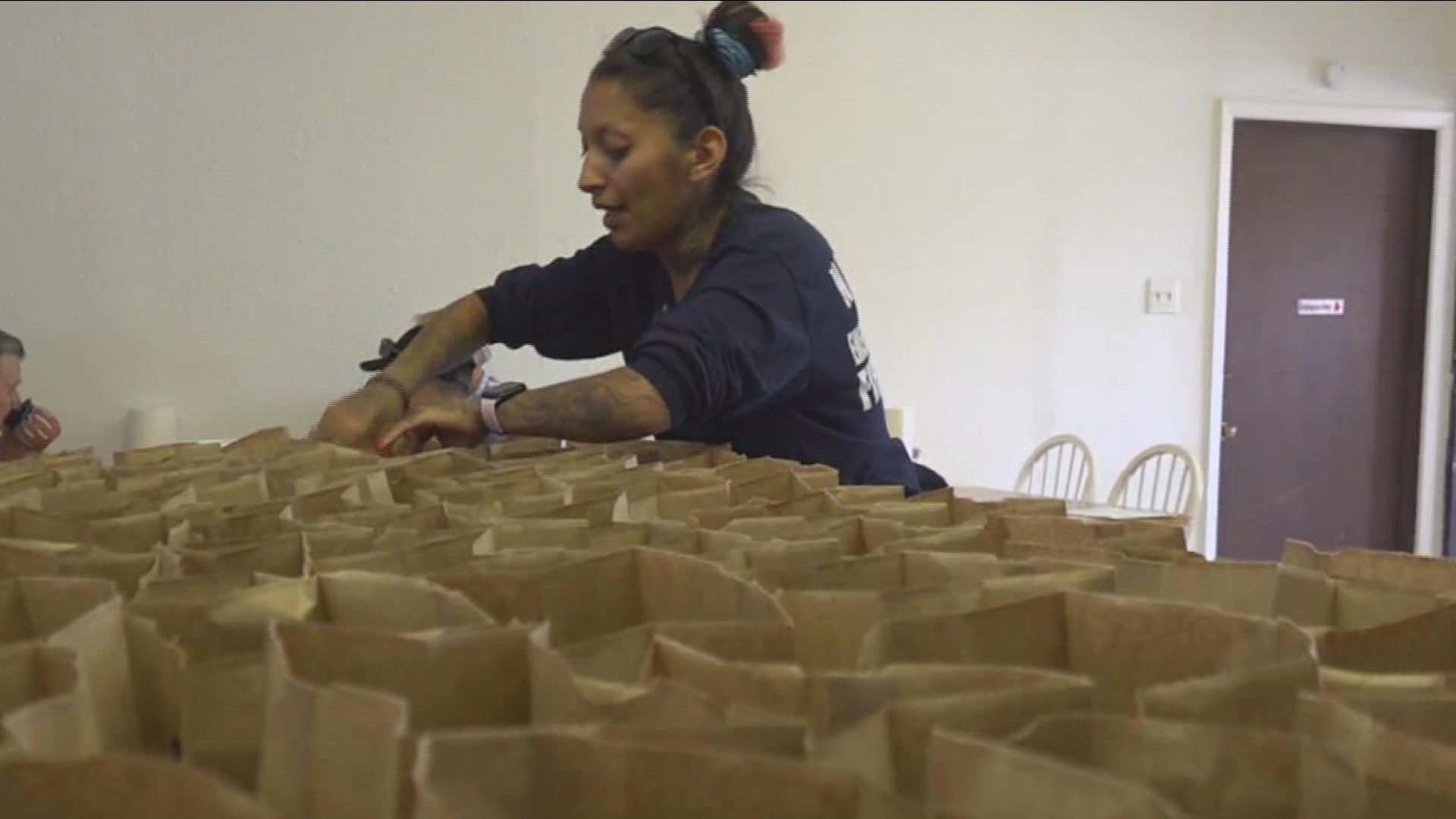 Mainstreet Cafe Owner, Erica Garcia and her staff  line up sack lunches for children who are out of school for summer break.