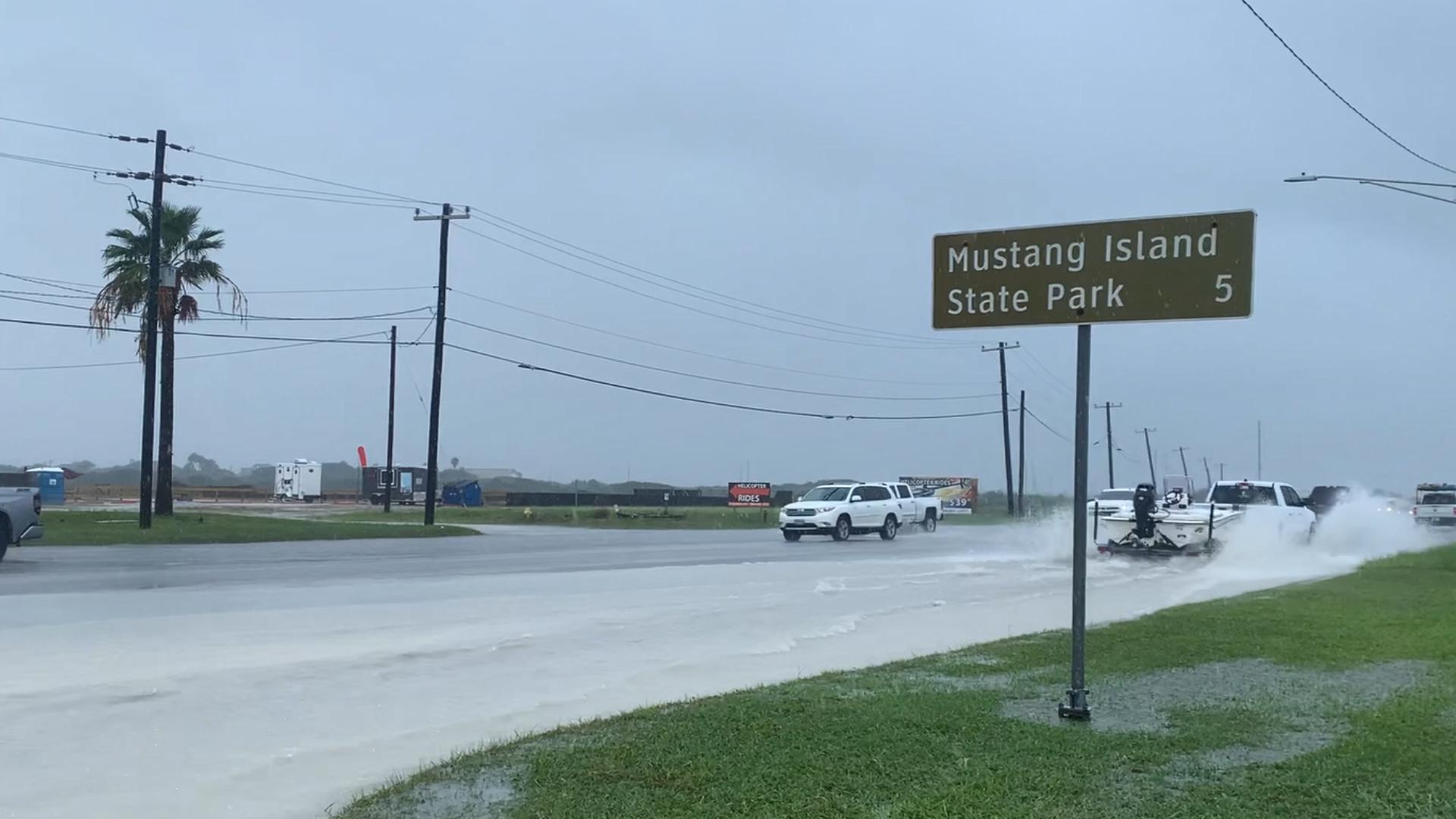 Water pooled on the side of State Highway 361 as traffic made its way to and from Mustang and Padre islands Monday.