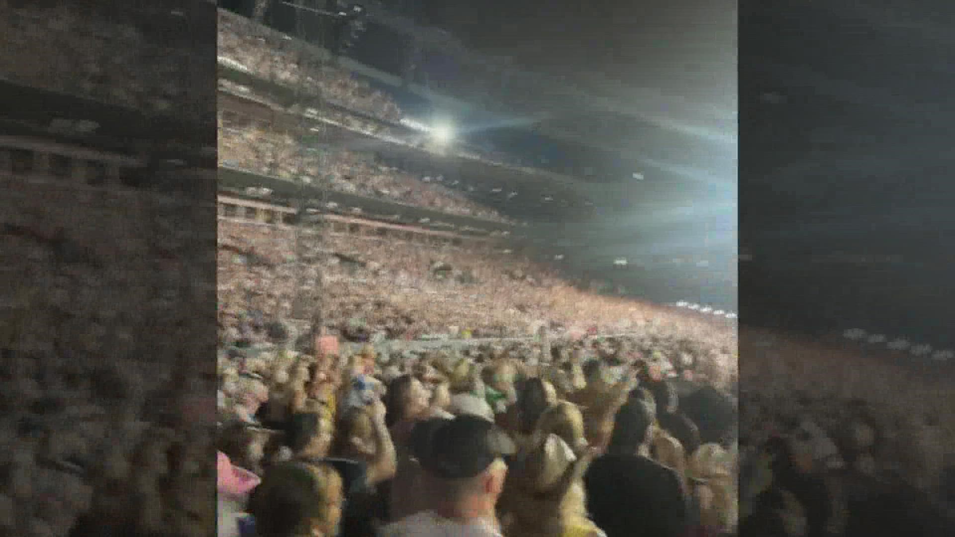 The woman was attending a Kenny Chesney concert at the stadium when she died after falling from an escalator railing, police said.