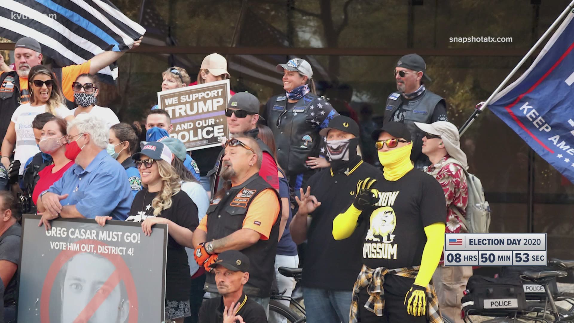 The police department has opened an internal affairs investigation after some officers posed for a photo with protesters gesturing the "white power" hand symbol.